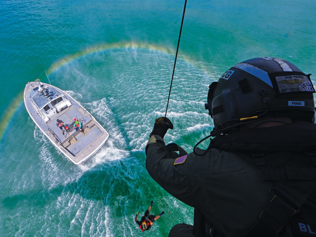 Rescue swimmer deploying near boat