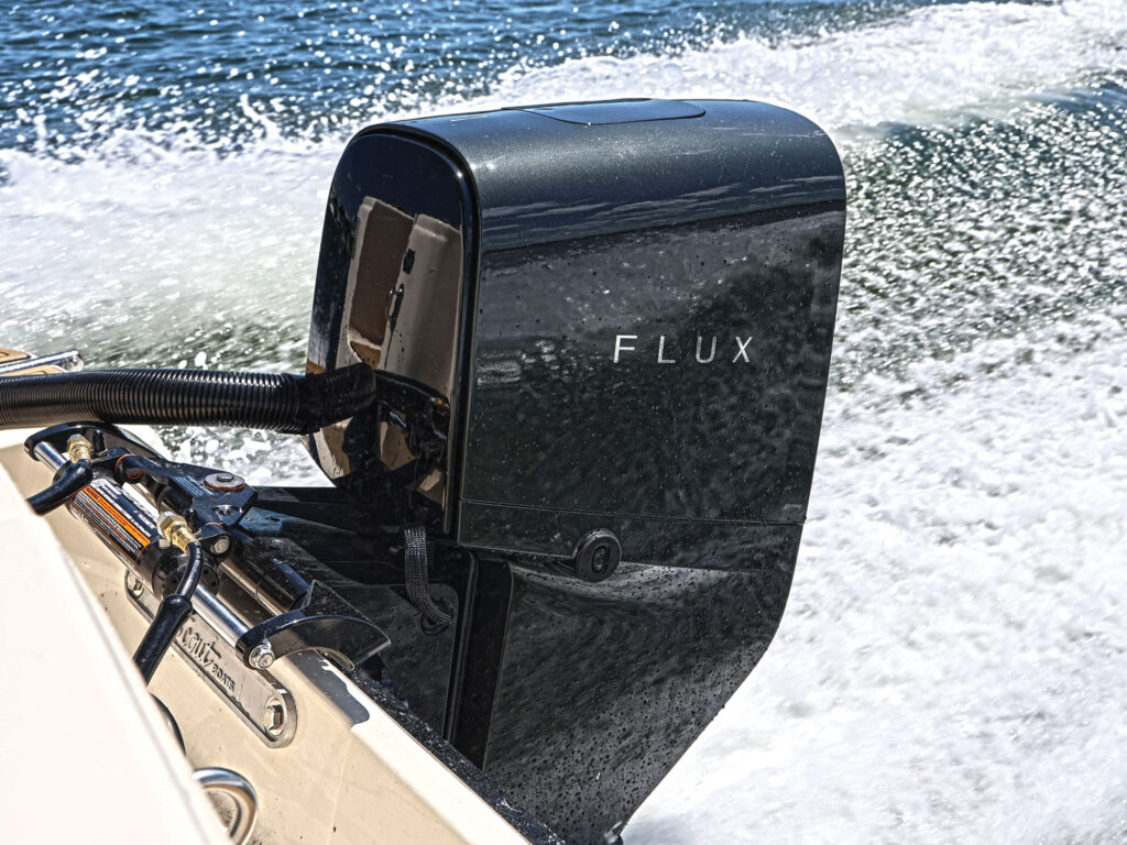 Flux electric outboard powering a boat