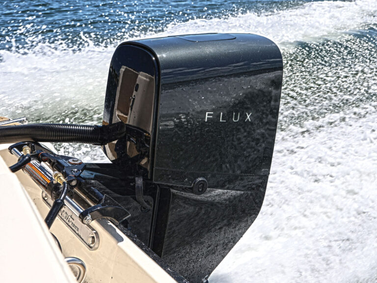 Flux electric outboard powering a boat