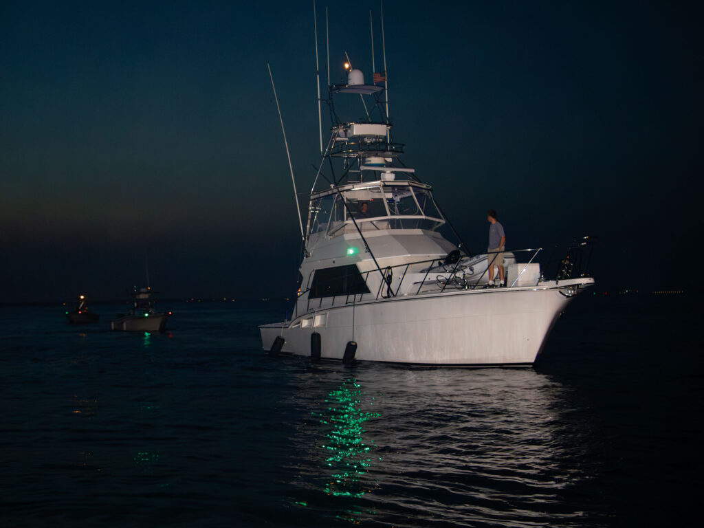 Large sportfishing boat at night