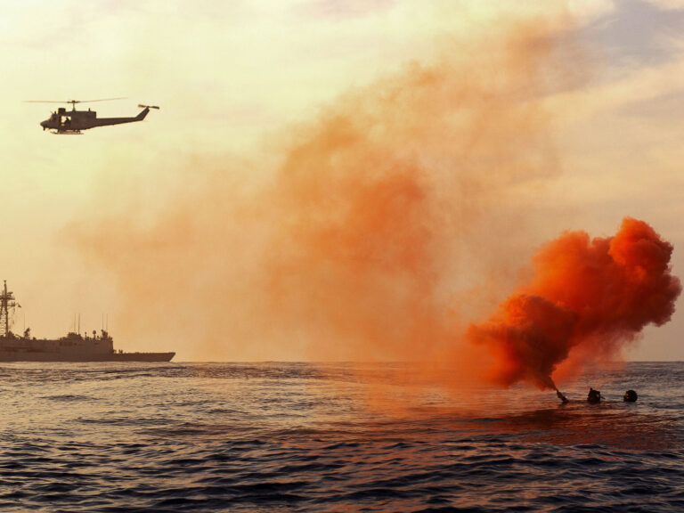 Boater with flare being rescued
